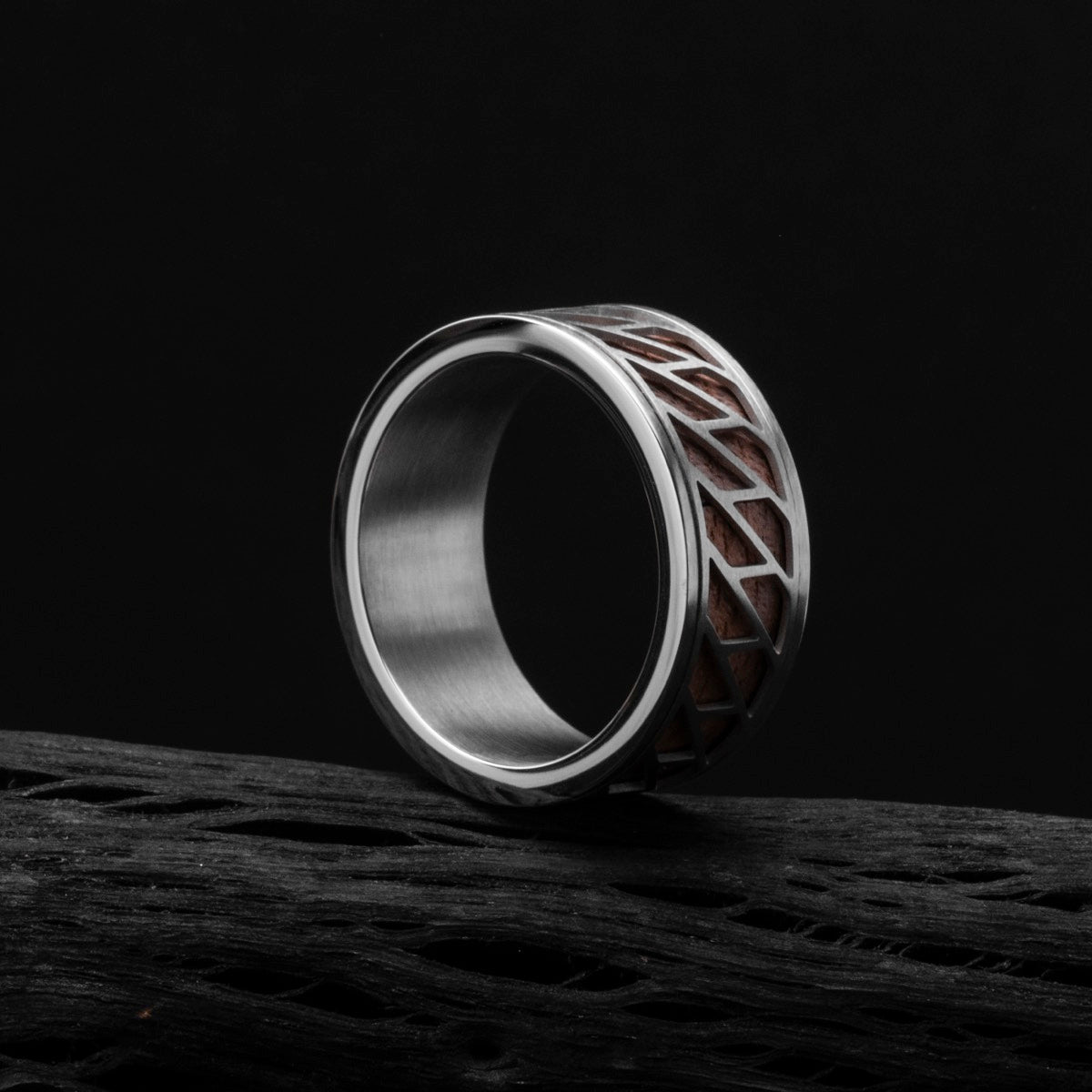 "Baritone Rings", a stylish ring featuring a silver frame and walnut wood accents on a dark background.