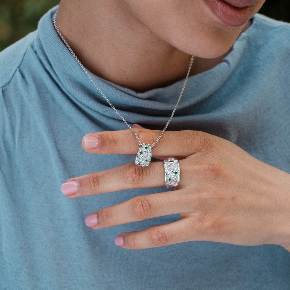 "Silverstream Necklace necklace featuring diopside and silver design, worn elegantly with a matching ring."