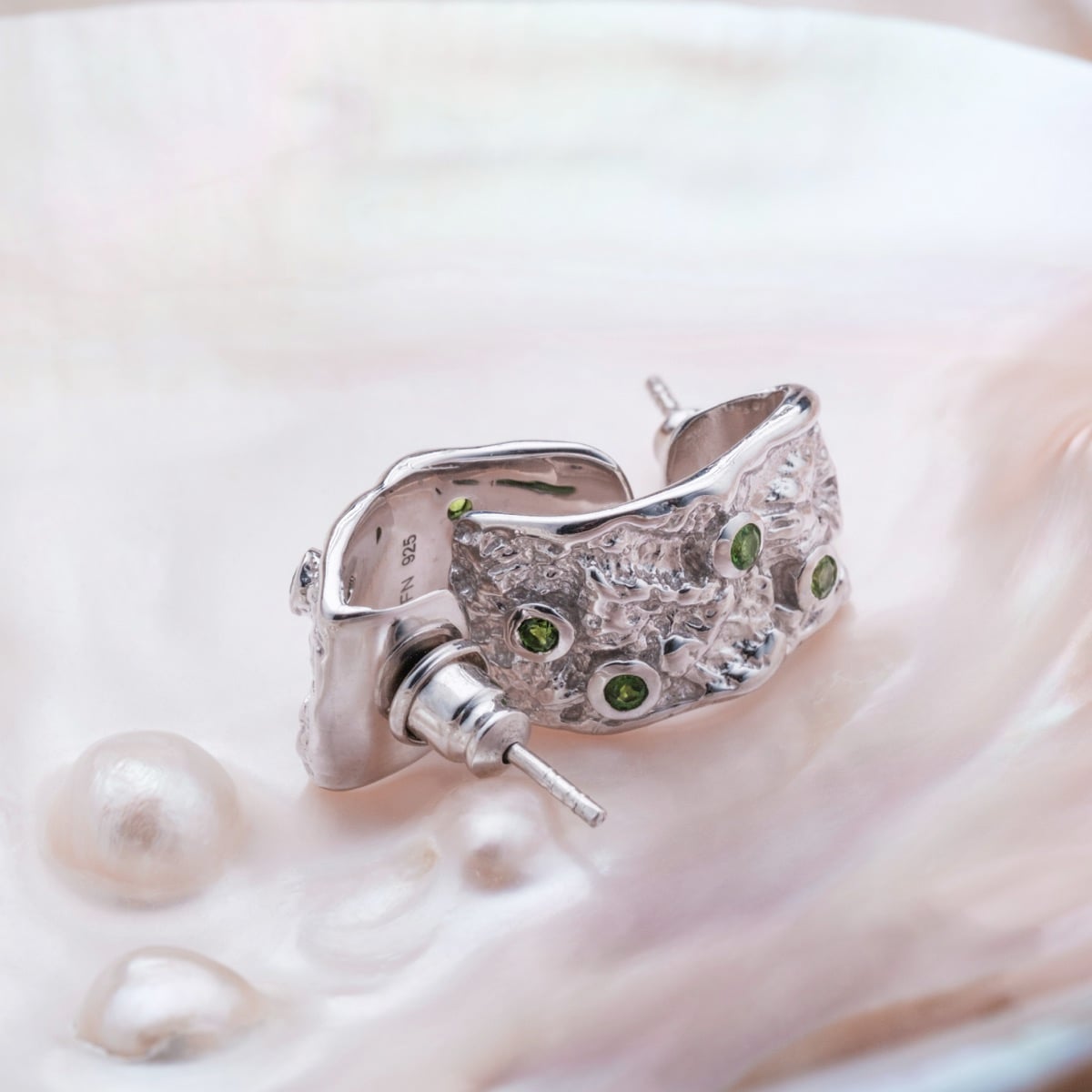 "Silverstream Earrings" earrings feature a textured silver design with vibrant diopside accents.