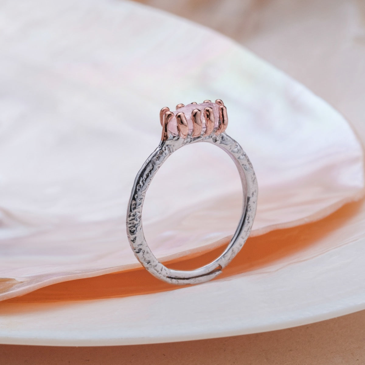 "Silverstream Ring, a rosegold ring with a rose quartz setting, featuring an elegant and textured design."