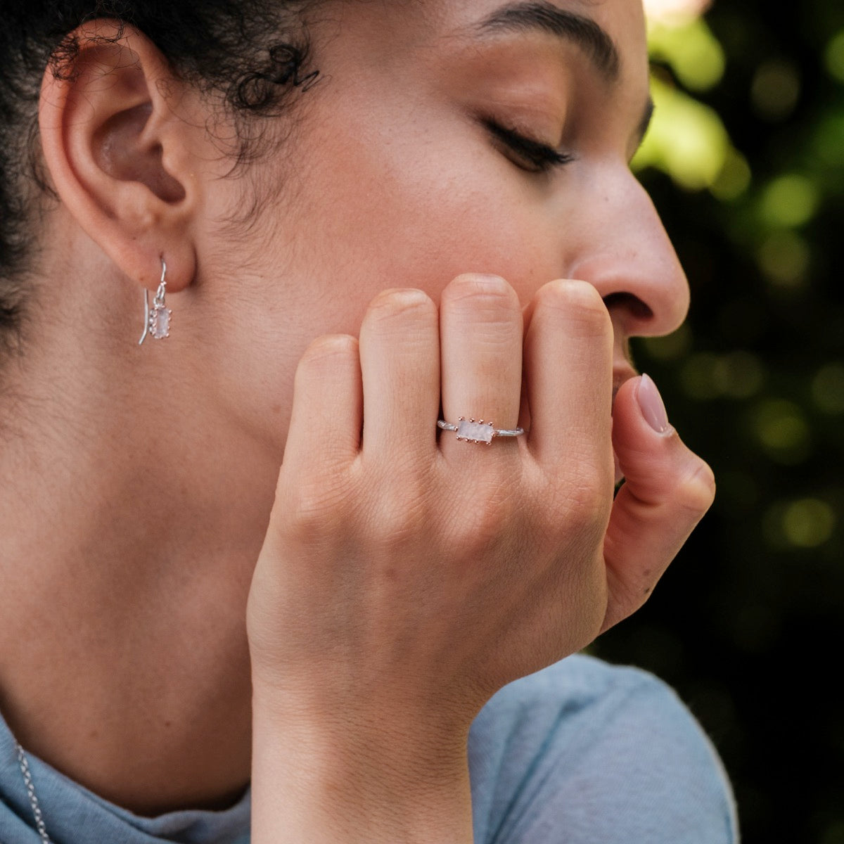 "Silverstream Ring ring featuring rose quartz in a rosegold setting, worn gracefully on a hand for an elegant look."