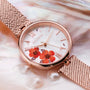 Orologio "Everbloom" in fiore di prugne e oro rosa con dettagli floreali intricati sul quadrante.