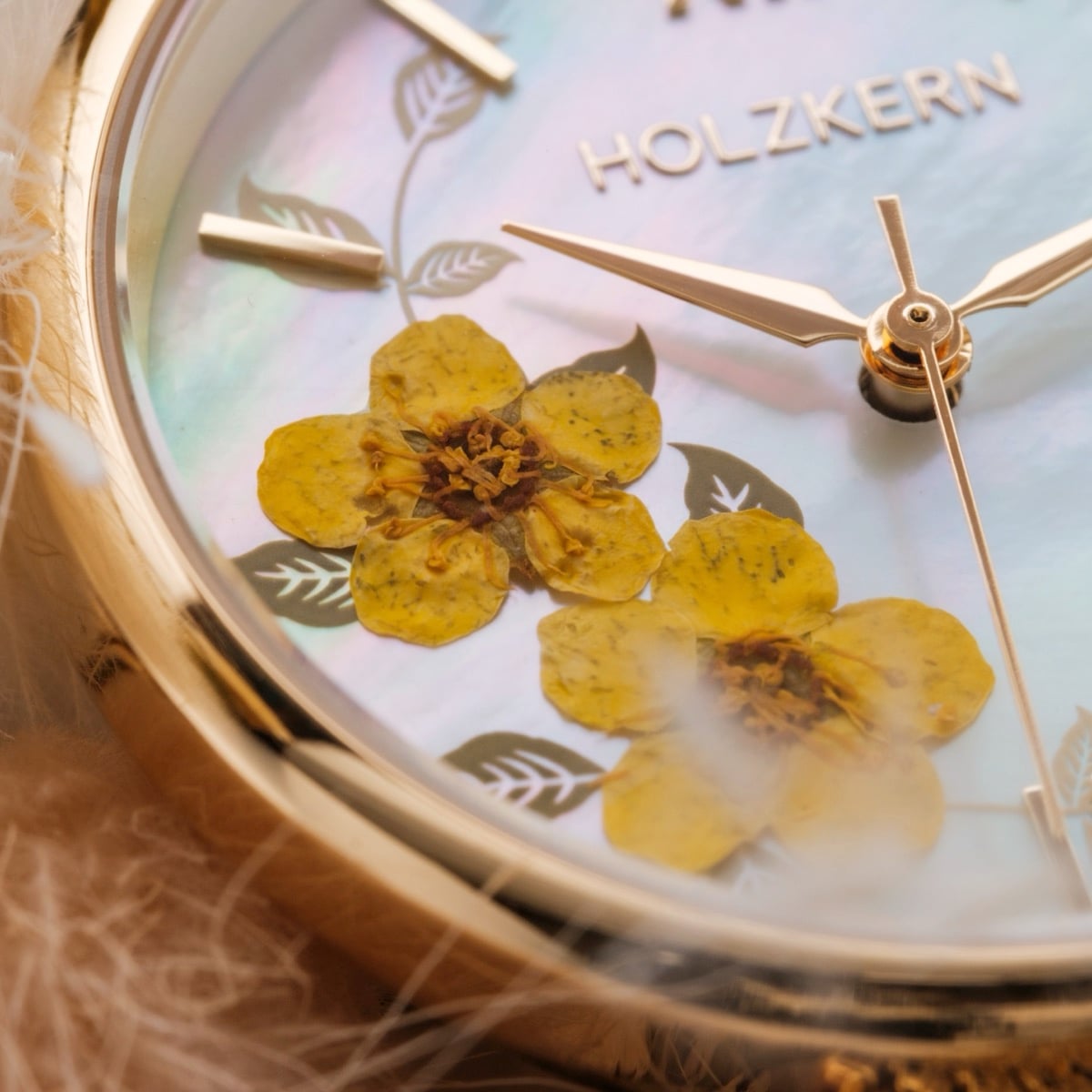 Orologio "Everbloom" con cassa in oro e disegno a fiori di prugne sul quadrante per un look elegante.