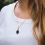 "Mandala Necklace pendant necklace featuring a geometric design in marble and rose gold on a delicate chain."
