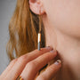 Elegant "Campania Earrings earrings featuring a sleek marble and gold design."