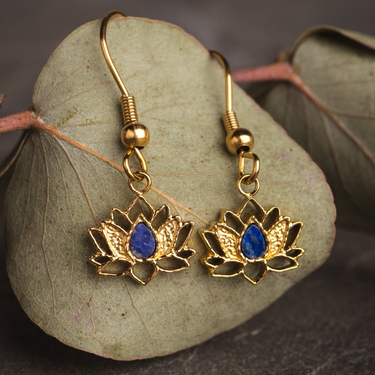 "Balance Earrings" earrings feature a lotus design with lapis lazuli and gold accents, offering a stylish and elegant look.