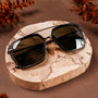 "The Storyteller sunglasses featuring a Leadwood and Antique Silver design on a rustic wooden background."