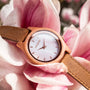 "Cinque Terre watch featuring a cherrywood case and nacre dial, set against a floral backdrop."