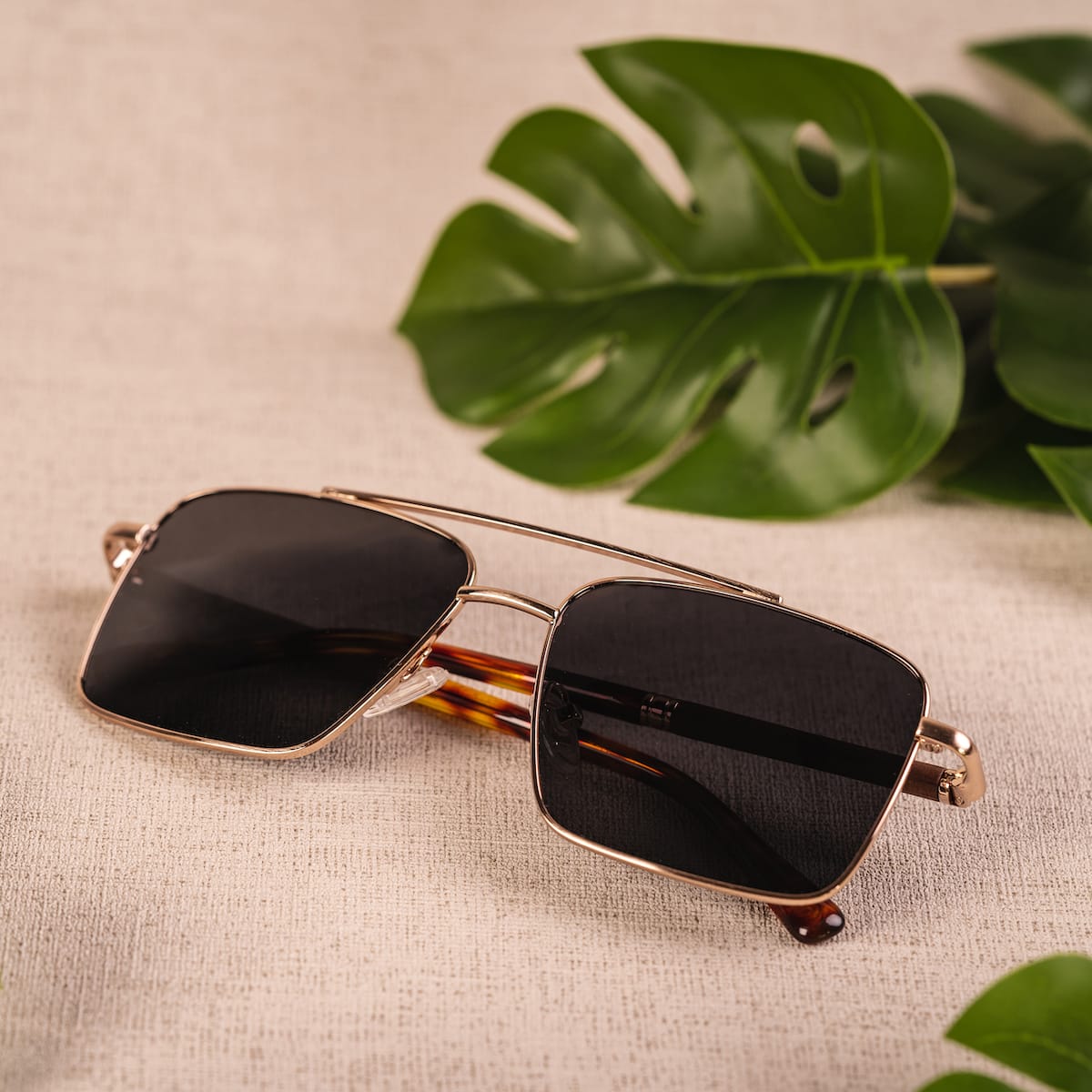Gli occhiali da sole "The Talisman" sono caratterizzati da un design elegante in noce e oro opaco con un'estetica moderna.