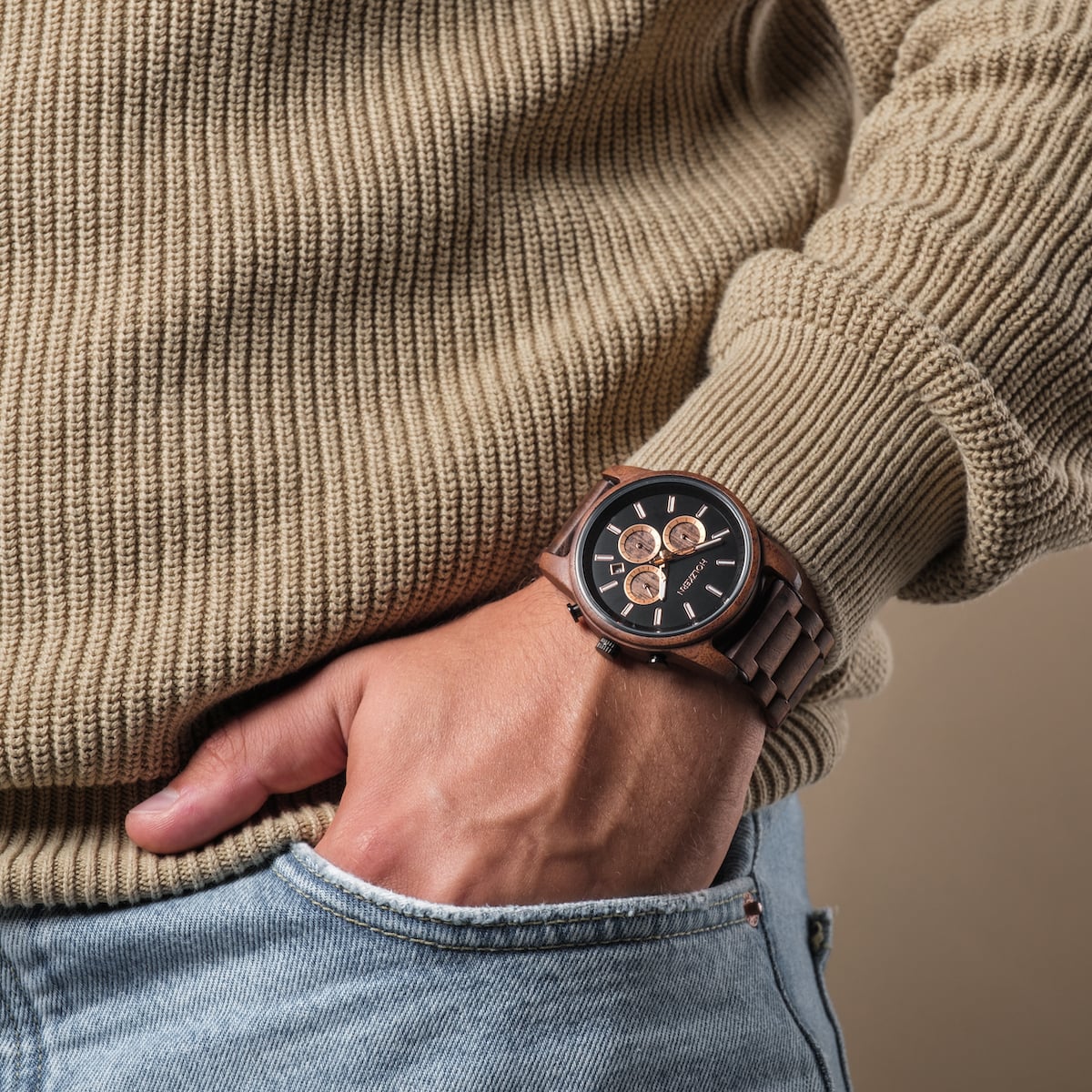 "Thicket" wristwatch featuring a walnut and marble design, worn with casual attire for a stylish look.