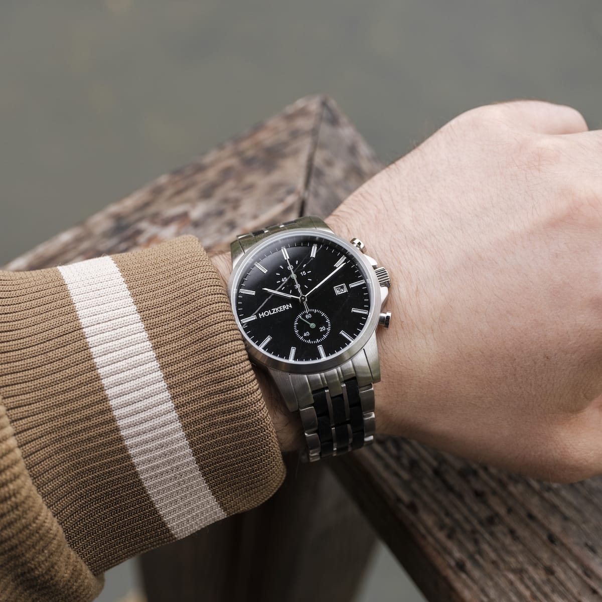 "The Observant watch with a sleek maple and marble design on a wrist in a casual setting."