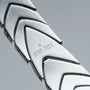"Command", a sleek silver bracelet with a polished jade accent, featuring a futuristic, modern design.