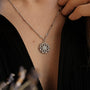 Elegant "Composition Gem Necklace" necklace features a moonstone centerpiece with a silver design, offering a sophisticated look.