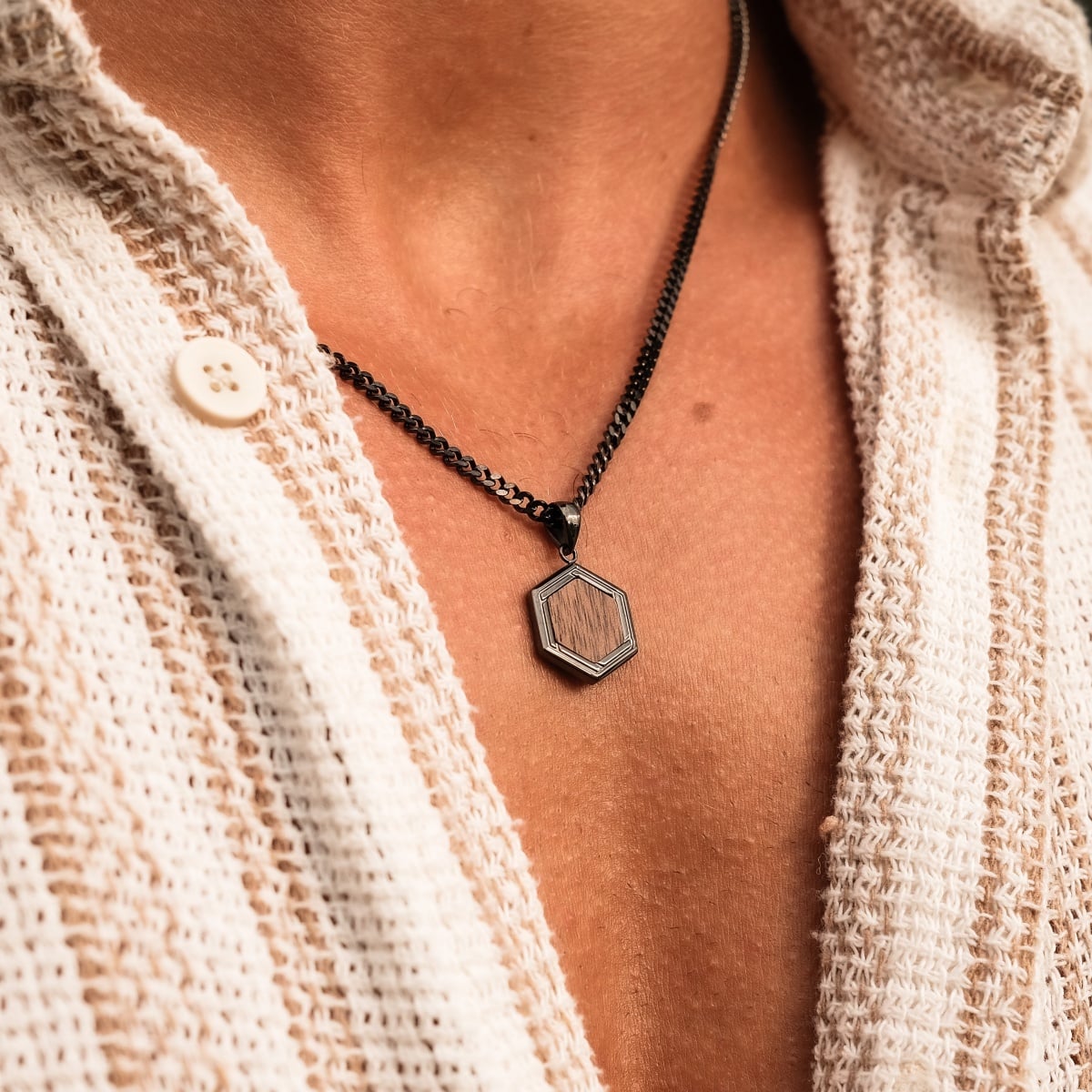 "Axis Necklace", a stylish walnut and dark grey hexagonal pendant necklace, adds a touch of elegance to any outfit.