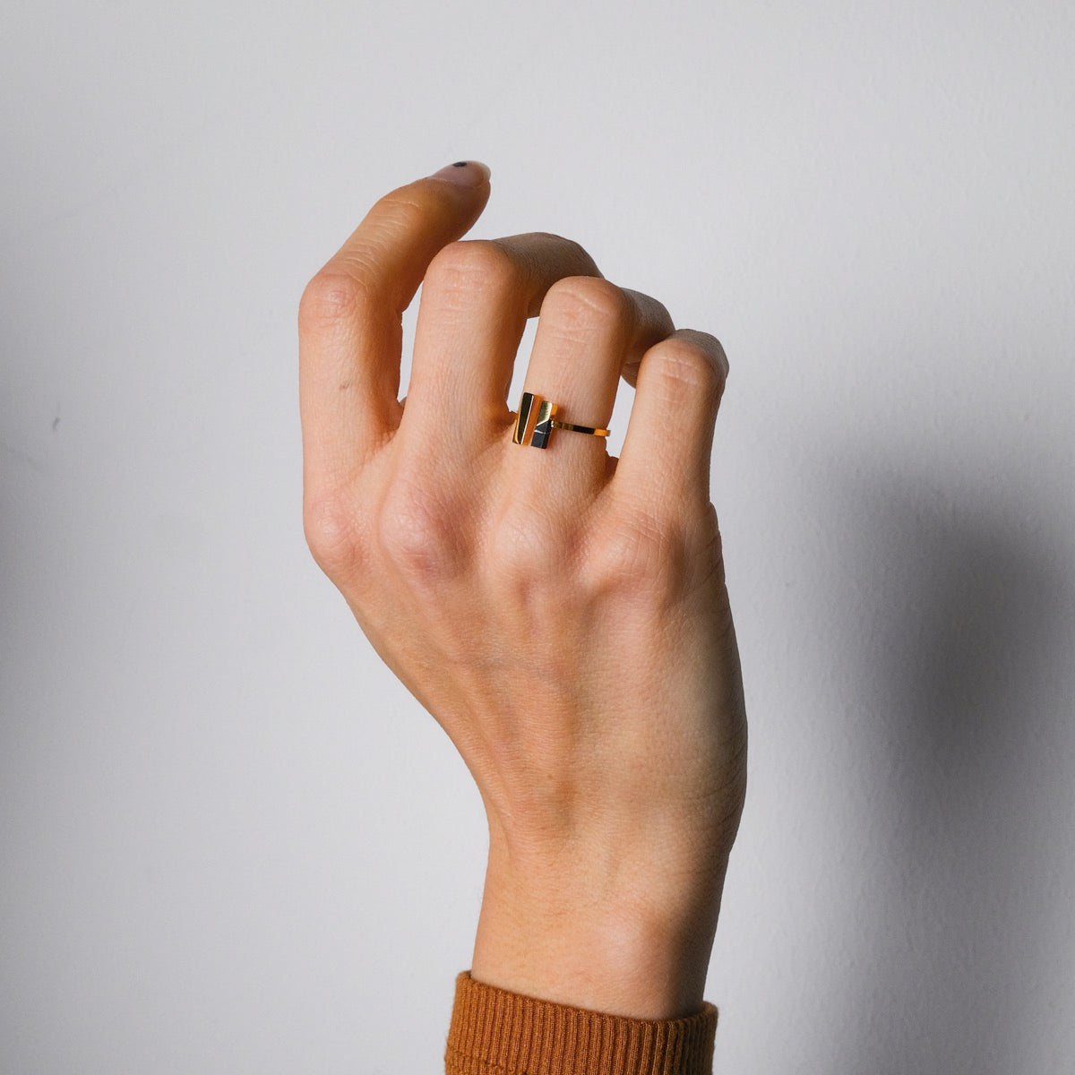 "Campania Ring": modern marble and gold ring showcasing sleek design.