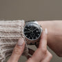 "The Observant wristwatch featuring a sleek design in maple and marble materials, with a modern, minimalistic silver-tone look."
