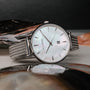 "Piccolo" wristwatch featuring a mother-of-pearl dial and silver mesh band for an elegant look.