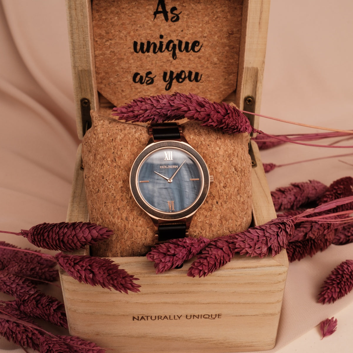 "Maui" watch with a maple and nacre design, elegantly displayed in a wooden box with decorative dried flowers.
