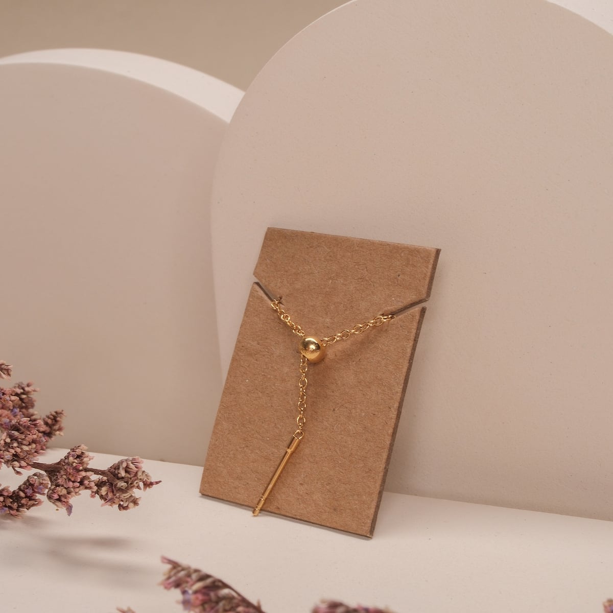 "Jewelry Extender", a gold jewelry extender, displayed elegantly on a minimalist background.