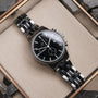 "The Observant, a sleek wristwatch featuring a black dial with a maple and marble band."