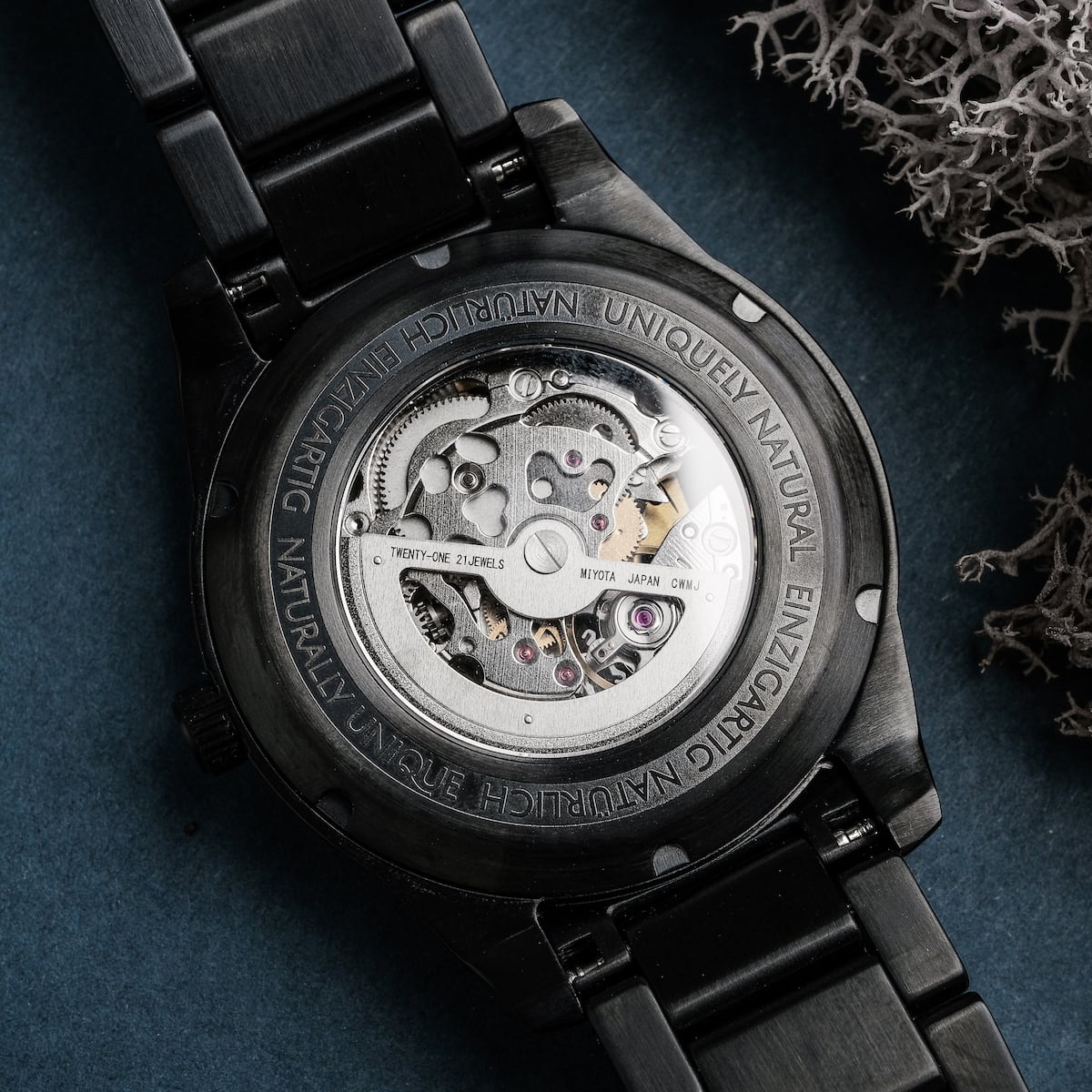 "Adrenin watch featuring a sleek black design with intricate mechanical details and walnut accents."