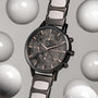 "Breezy watch with marble face and ceramic strap, surrounded by floating spheres, modern and elegant design."