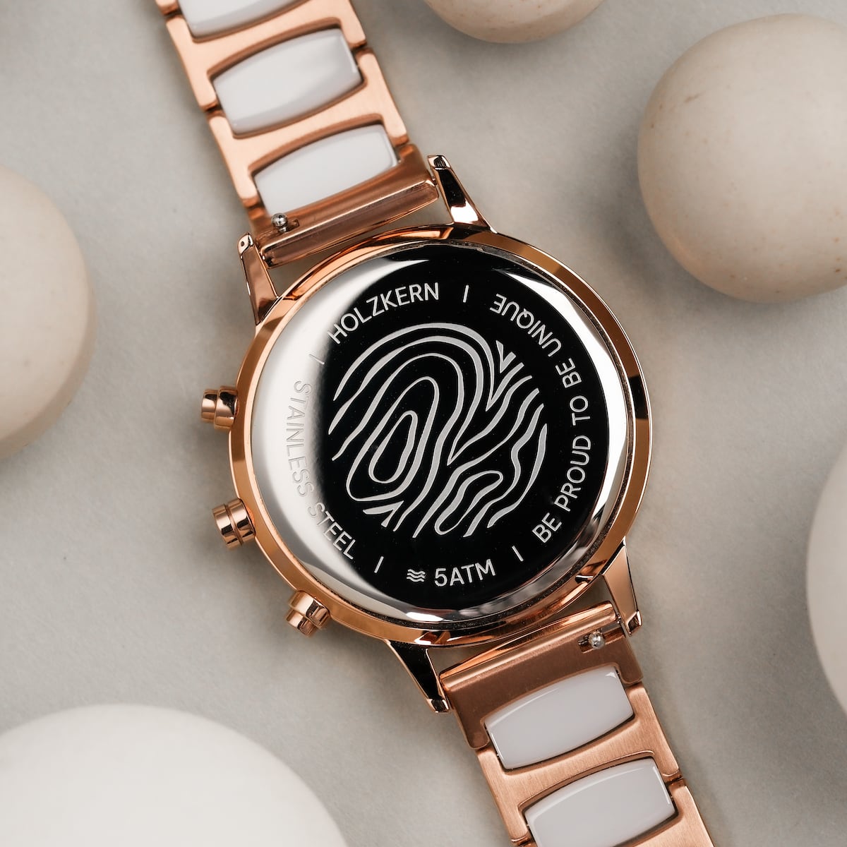 "Shiny" watch featuring nacre and ceramic materials with a sleek, shiny, rose gold aesthetic.