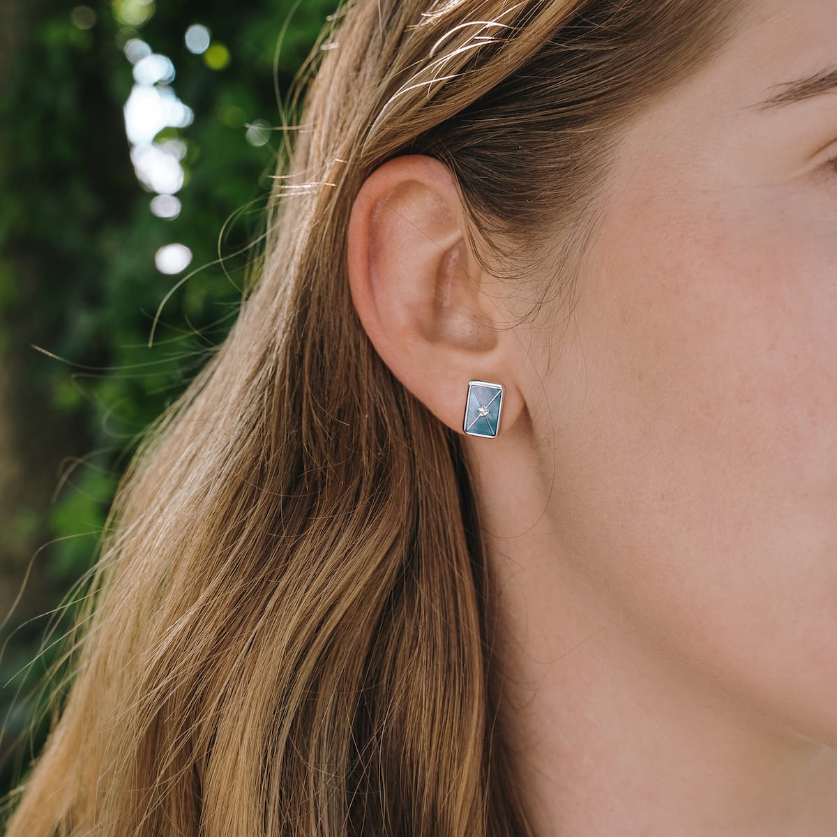 "Aquarell Earrings" earrings featuring a rectangular blue nacre design with silver accents, offering a modern and elegant style.