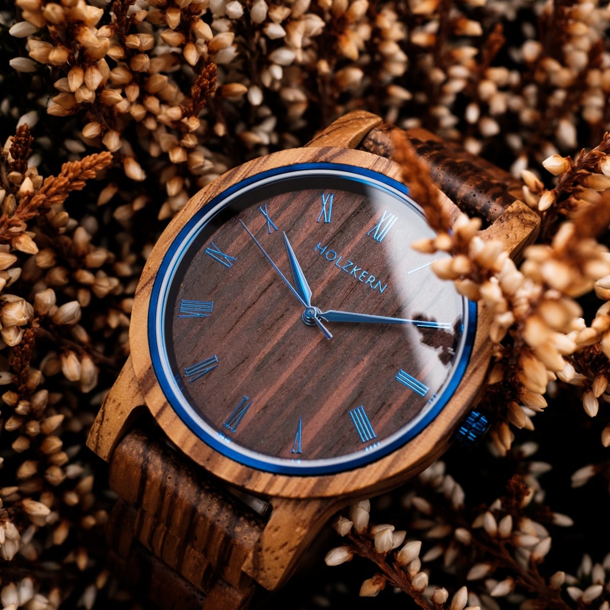 "Fall Morning" watch with Zebrawood/Wenge finish nestled in autumn flowers, featuring a rustic and elegant design.