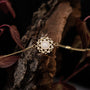 "Composition Gem Bracelet" bracelet featuring moonstone and gold with an elegant, intricate design.