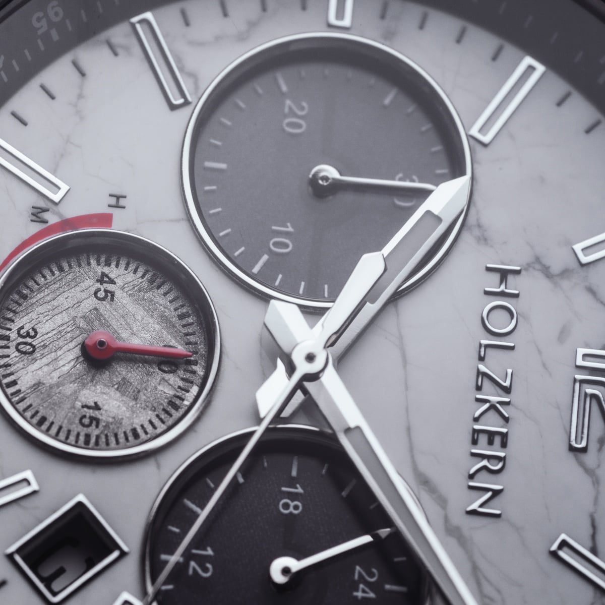 "Sagres" watch featuring a marble-silver finish and a detailed, modern design.