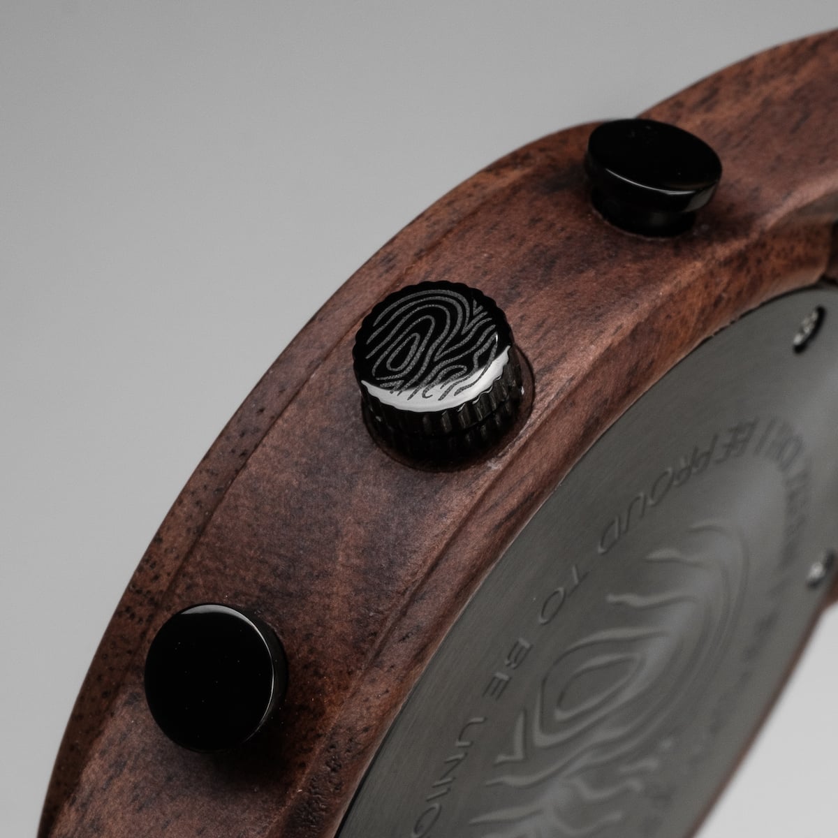"Thicket" watch with walnut wood and marble style, featuring detailed side buttons and a textured dial.