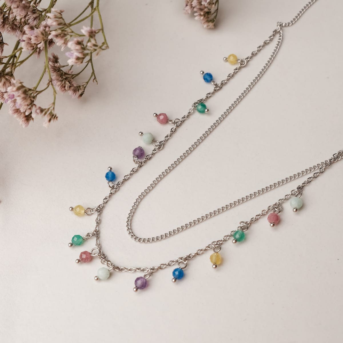 "Free Play Necklace", a chic necklace with colorful beads and silver chains, offering a vibrant and trendy style.