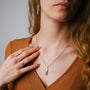 "Campania Ring", a stylish ring in walnut and silver, worn by a hand with complementary jewelry.