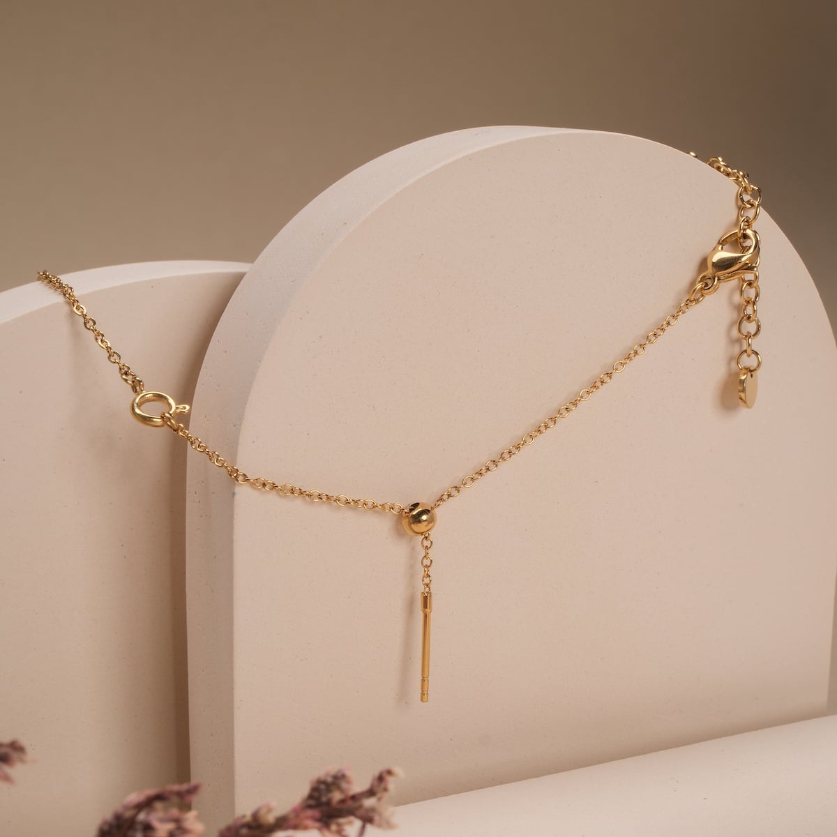"Jewelry Extender", a gold jewelry extender, elegantly styled on a neutral backdrop.