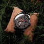 "Pacemaker watch with a marble/marble design featuring a striking geometric pattern and vibrant red accents."