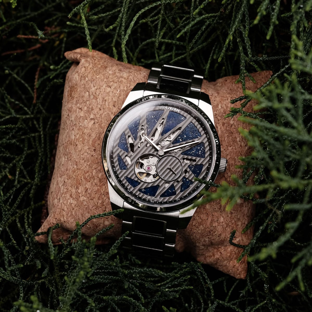 "Spikes watch, featuring Lapis Lazuli and Maple, with a modern, textured design against a natural green backdrop."