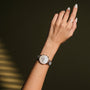 "Shiny" watch with nacre dial and ceramic strap, featuring a sleek and modern design on wrist.