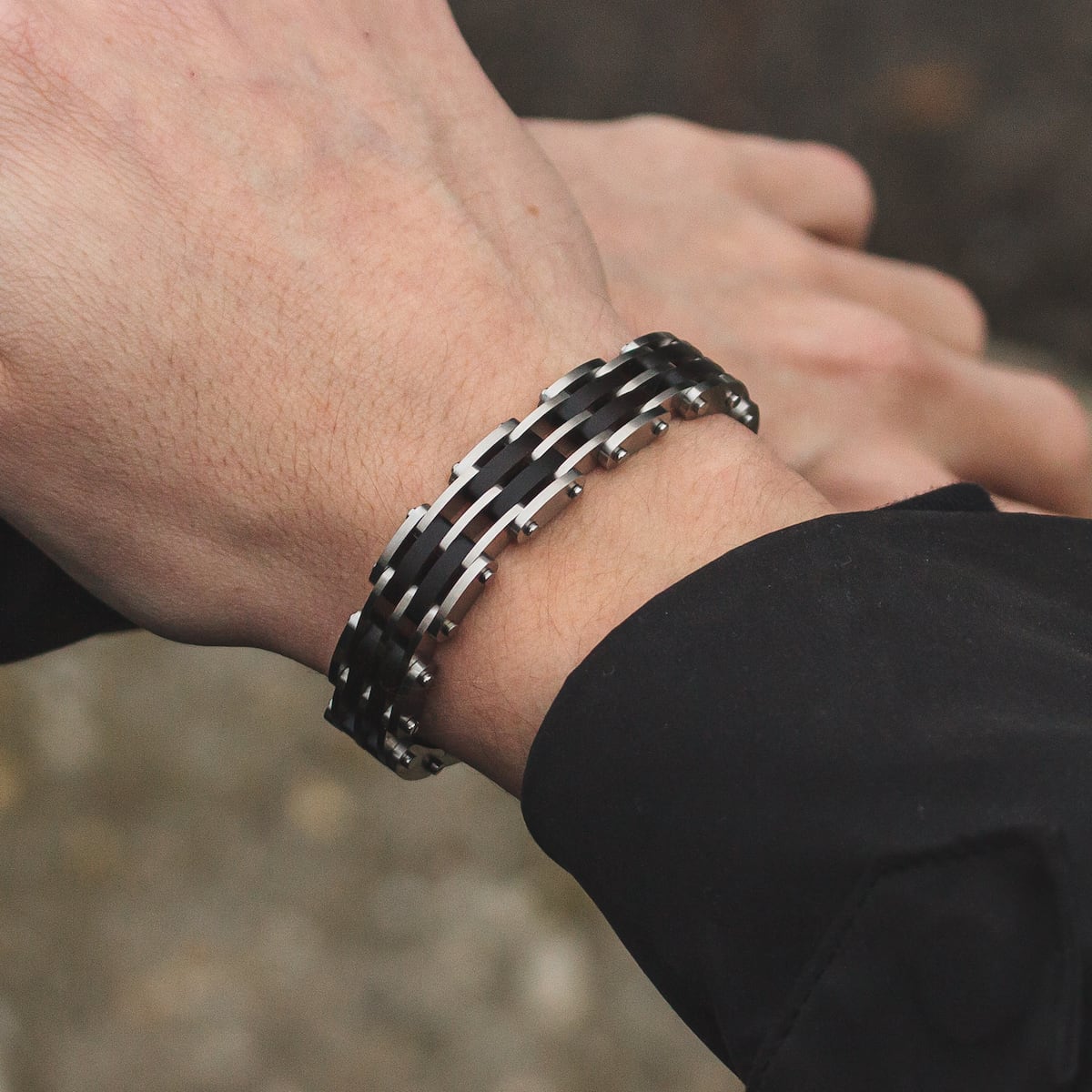 "Adagio" bracelet featuring maple with silver accents, worn on wrist, showcasing a sleek and modern design.