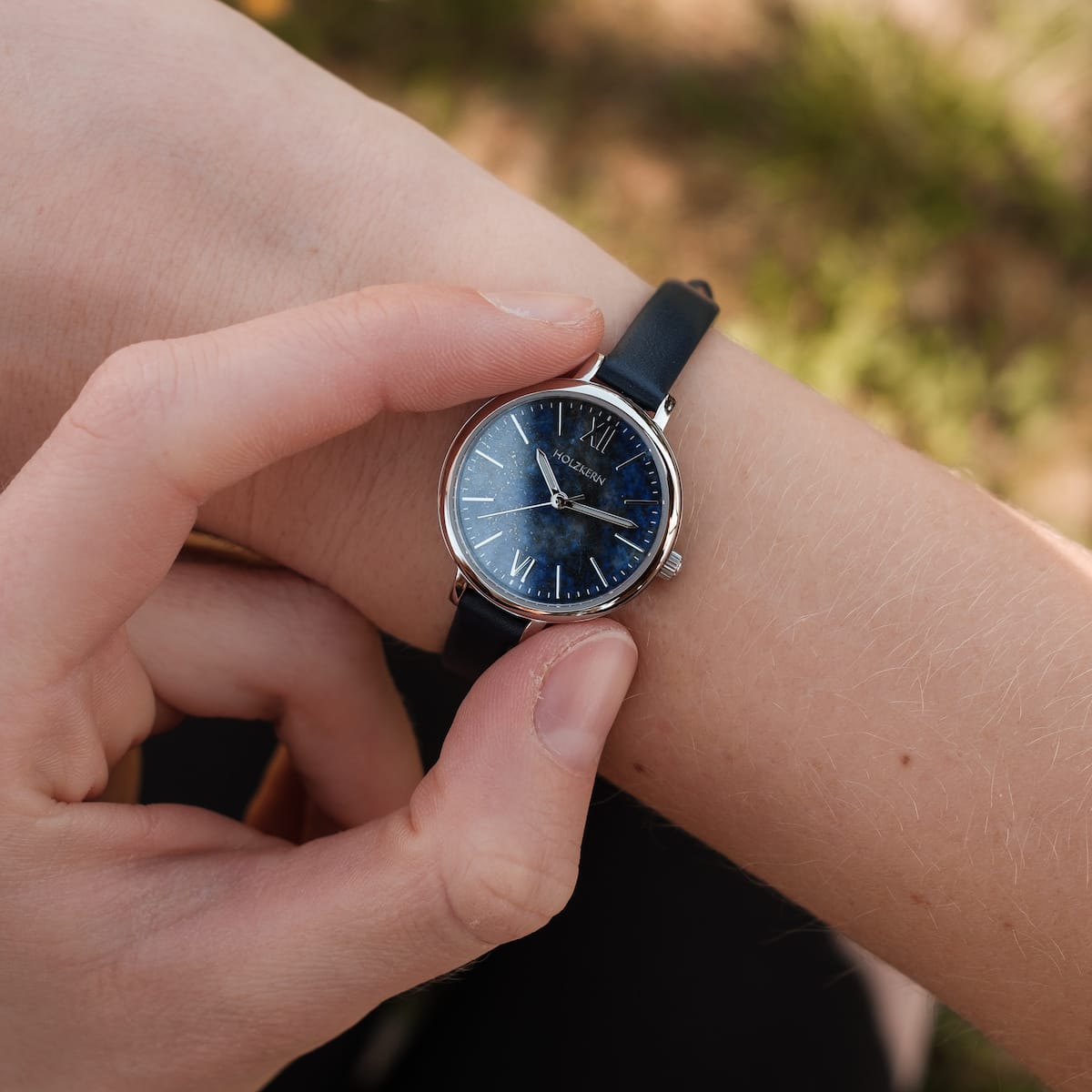 "Teresa" watch with a Lapis Lazuli-styled face and silver accents, featuring a sleek strap design.