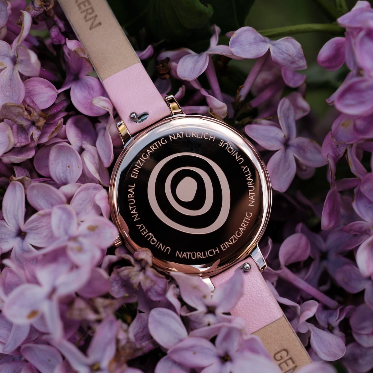 "Alva" watch featuring marble and rose gold design with a floral background.