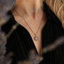 "Composition Gem Necklace": elegant rose gold necklace featuring a moonstone gem in a delicate design.