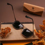 "The Storyteller sunglasses featuring a Leadwood frame and Antique Silver accents, styled with elegant charm."