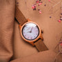"Cinque Terre watch features a cherrywood and nacre finish with a minimalist dial and leather strap."