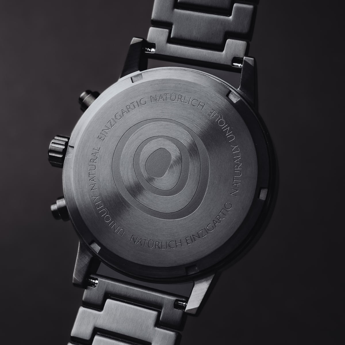 "Rahotu" watch in stylish marble and black design, showcasing its sleek back and metal bracelet.