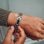 "Adagio" watch featuring a sleek blue marble face and silver band.