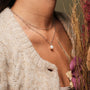 "Panoramic Necklace" necklace featuring a white pearl on a silver chain, elegantly styled for a chic look.