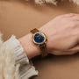 "Balos" watch with zebrawood strap and marble dial, featuring a chic and natural design.
