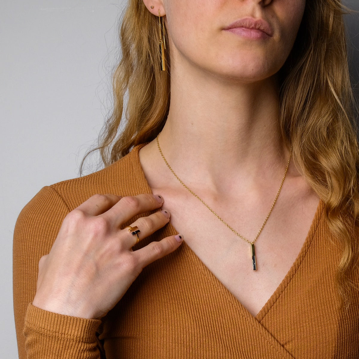 "Campania Ring" is a stylish marble and gold ring with a modern, elegant design.