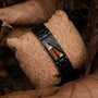 Bracciale "Looper" con zebrawood e elementi neri, in stile elegante e moderno.